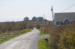 There were several modern homes on this road. It's high and you can see down onto water on one side and flat land that leads to water on the otherl.
